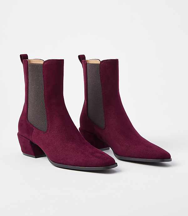 A pair of burgundy suede Chelsea boots with block heels are displayed against a plain white background.
