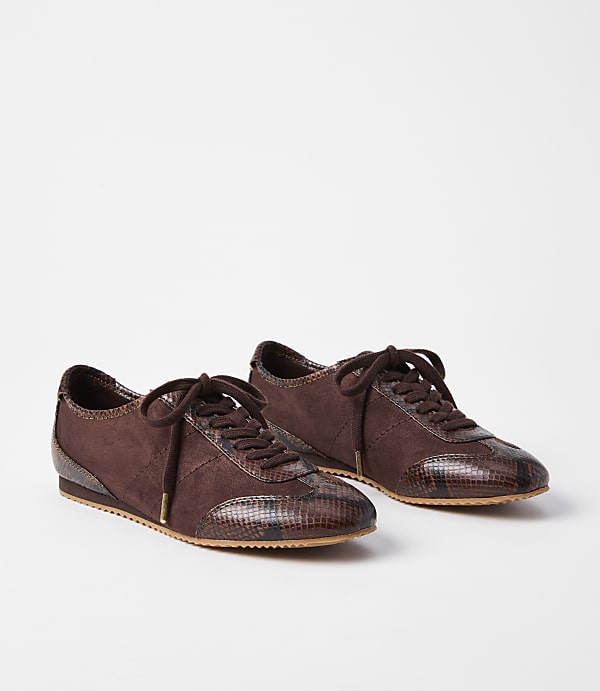 A pair of brown suede and snakeskin sneakers rests on a plain white background.