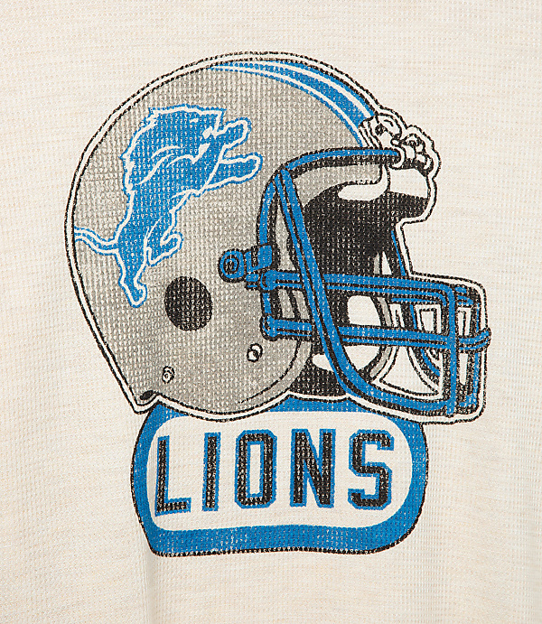A Detroit Lions helmet logo with the word "LIONS" below it is centered on a cream-colored textured background.