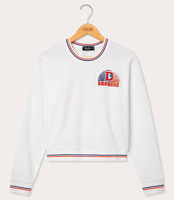A white sweatshirt with a Denver Broncos logo is hanging on a wooden hanger against a plain white background.