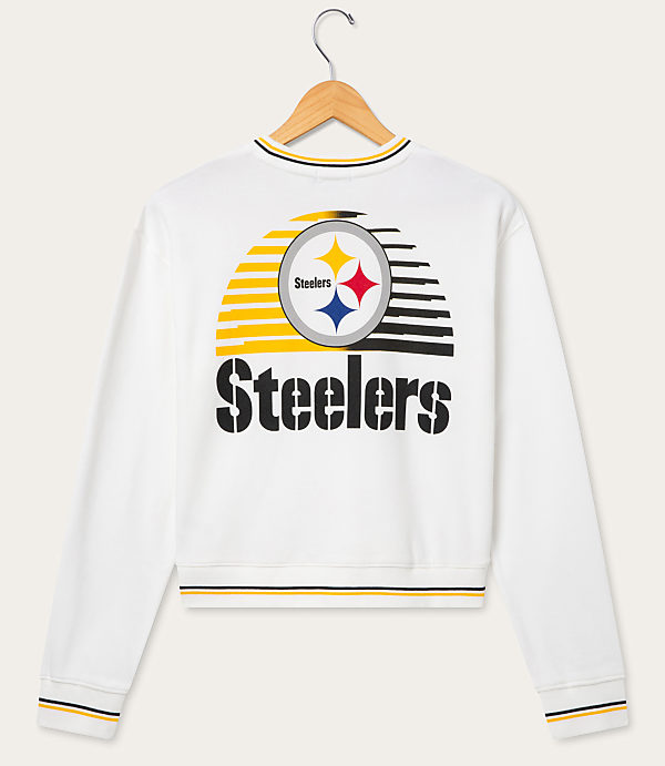 A white Pittsburgh Steelers sweatshirt with a graphic logo on the back hangs on a wooden hanger against a plain white background.