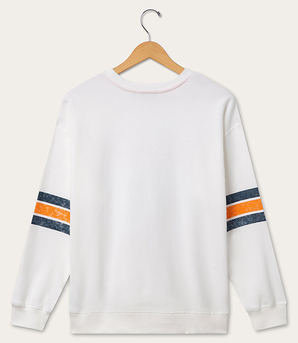 A white sweatshirt with orange and navy stripes on the sleeves hangs on a wooden hanger against a plain white background.