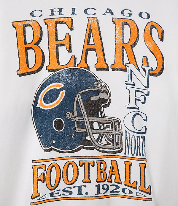 A white t-shirt features a distressed graphic of a Chicago Bears helmet and team name in the foreground, with "NFC North" and "Football Est. 1920" text in the background.