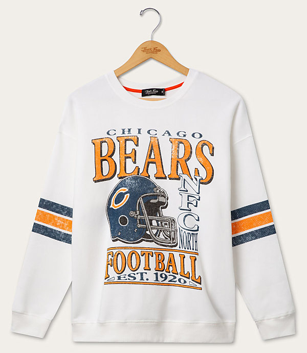 A white Chicago Bears sweatshirt with striped sleeves hangs on a wooden hanger against a plain white background.