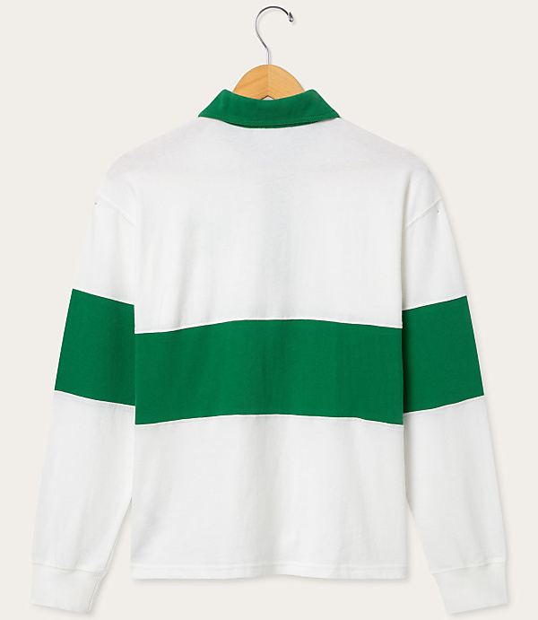 A white and green striped long-sleeved shirt hangs on a wooden hanger against a plain, light gray background.