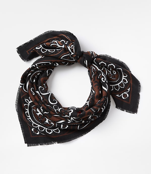 A black and brown paisley-patterned scarf with frayed edges is tied in a knot against a plain white background.