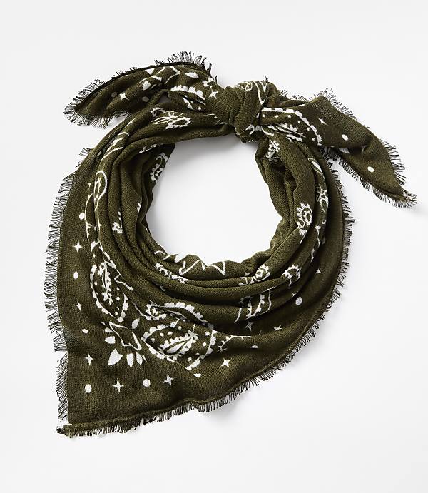 A green bandana with a white paisley pattern and frayed edges is tied in a knot against a plain white background.