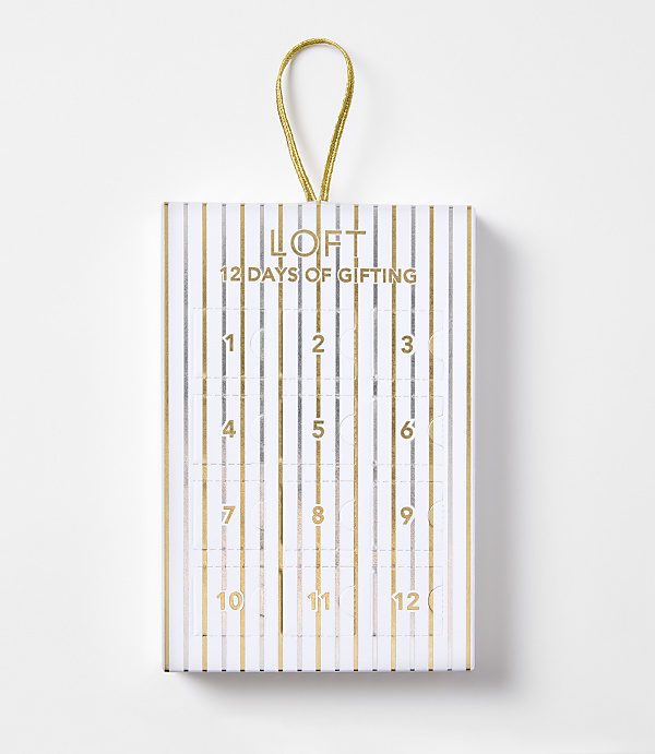 A white and gold striped advent calendar with "LOFT 12 DAYS OF GIFTING" printed on the front hangs against a plain white background.