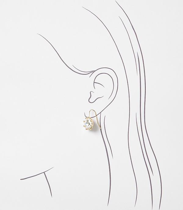 A delicate gold earring with a clear stone hangs from a sketched ear, set against a plain white background.