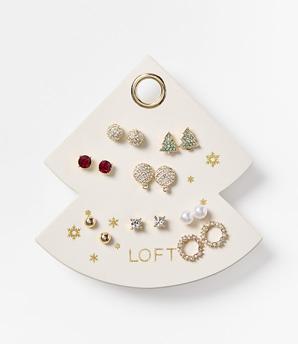 A white, Christmas tree-shaped earring display holds various festive earrings, with a plain white background.