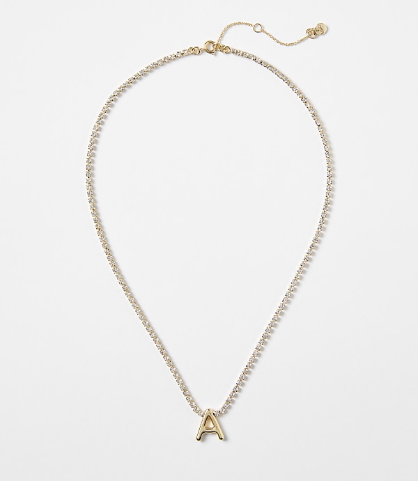 A gold letter "A" pendant hangs from a delicate, diamond-encrusted chain against a plain white background.