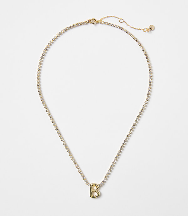 A gold necklace with a "B" charm and a white background.