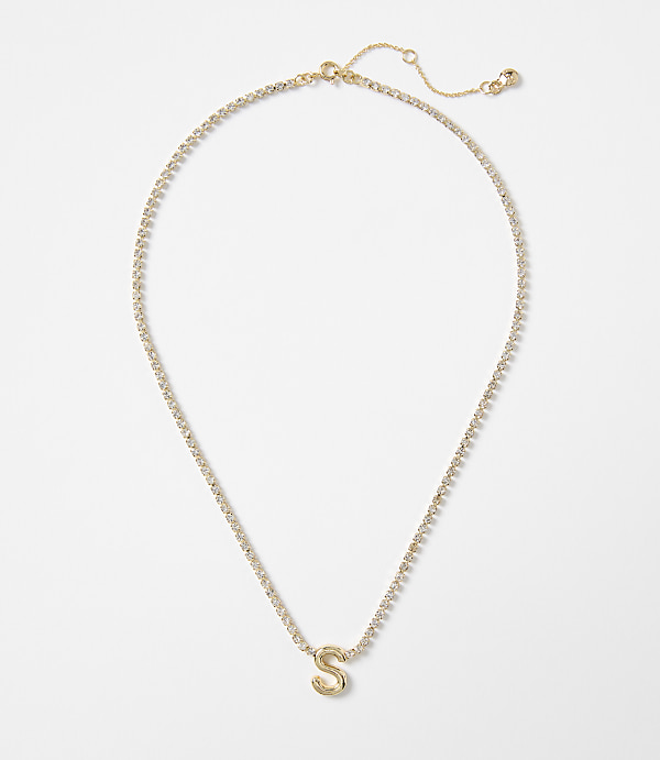 A gold letter "S" pendant hangs from a delicate, sparkling chain against a plain white background.