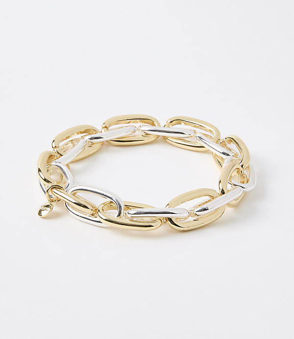 A chunky, two-toned gold and silver link bracelet rests on a plain white background.