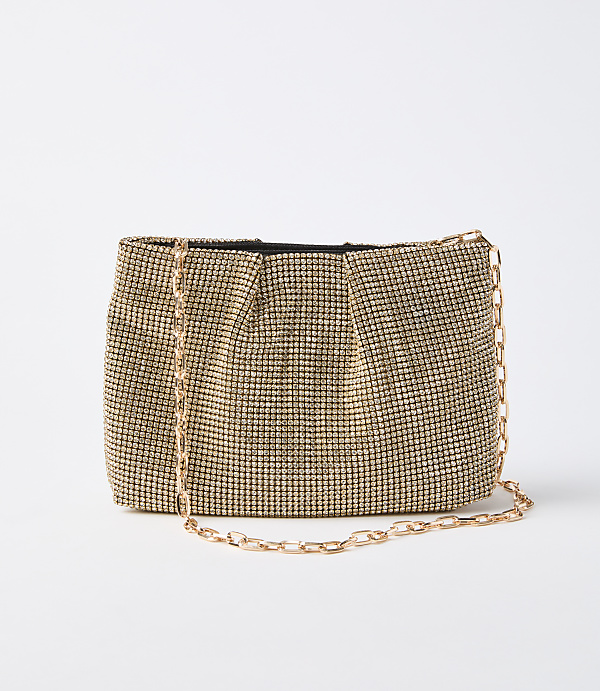 A gold rhinestone clutch with a delicate gold chain rests on a plain white background.