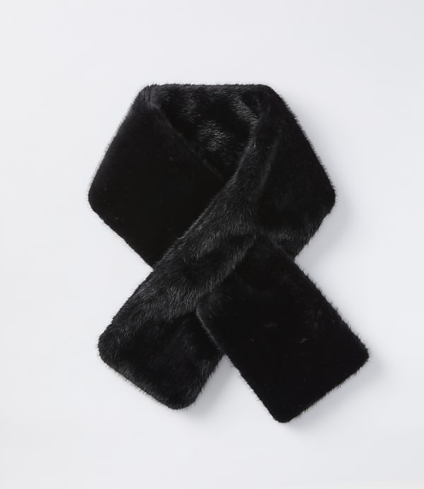 A black faux fur scarf is laid out in a knot on a plain white background.