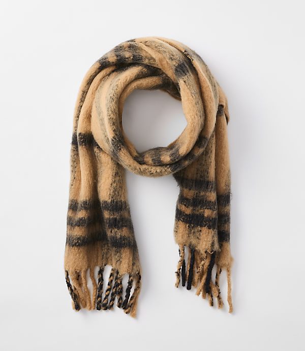 A fuzzy, tan and black striped scarf with fringed ends hangs against a plain white background.