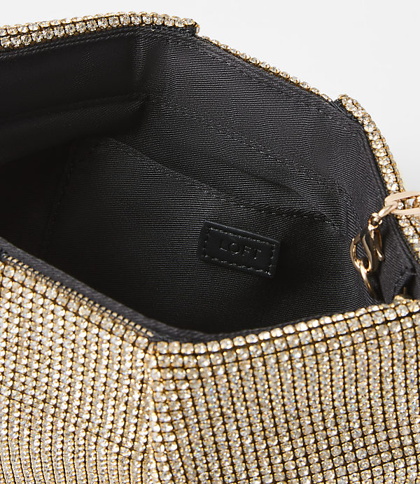 A sparkling gold clutch with a black interior is set against a plain white background.