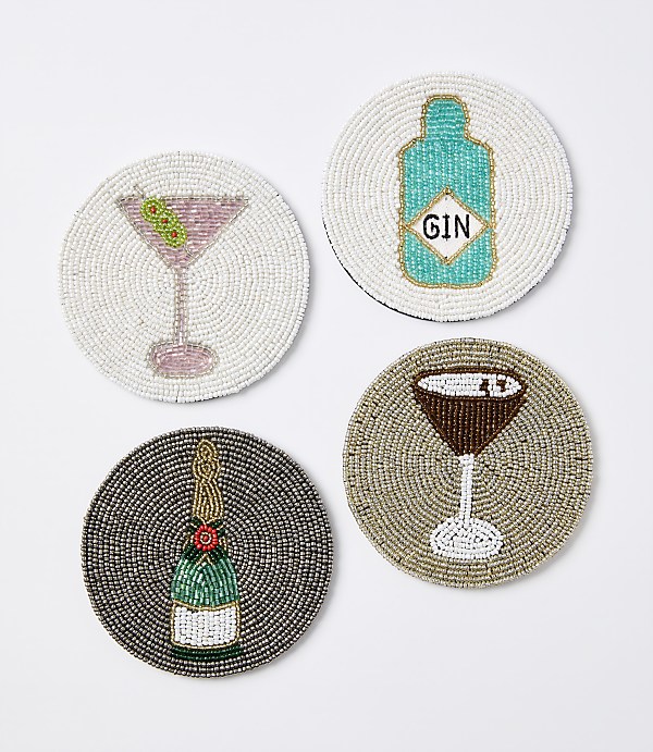 Four beaded coasters, each depicting a different alcoholic beverage, are arranged on a plain white background.