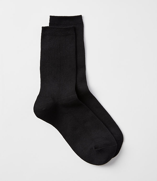 A pair of black ribbed socks rests on a plain white background.