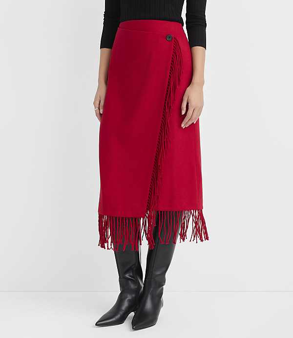 A red fringed wrap skirt with black boots is displayed against a plain white background.