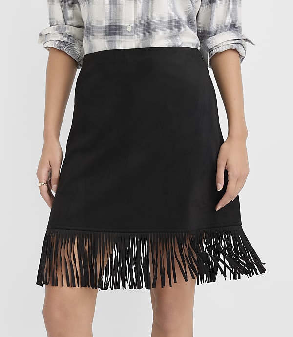 A black fringed skirt is worn by a person against a plain white background.