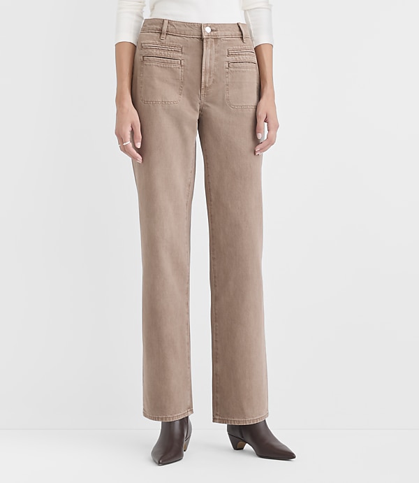 A person wears tan wide-leg pants and brown boots against a plain white background.