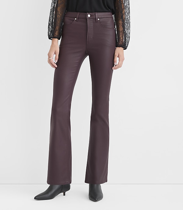 A person wears burgundy faux-leather flare pants and black boots against a plain white background.