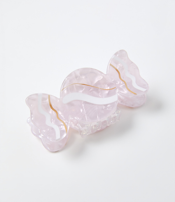 A pink, translucent butterfly-shaped hair claw clip with gold and white wavy accents rests on a plain white background.