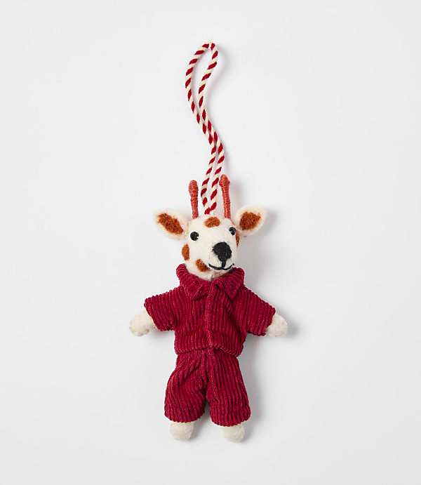A small felted deer ornament wearing a red corduroy outfit hangs from a red and white string against a plain white background.
