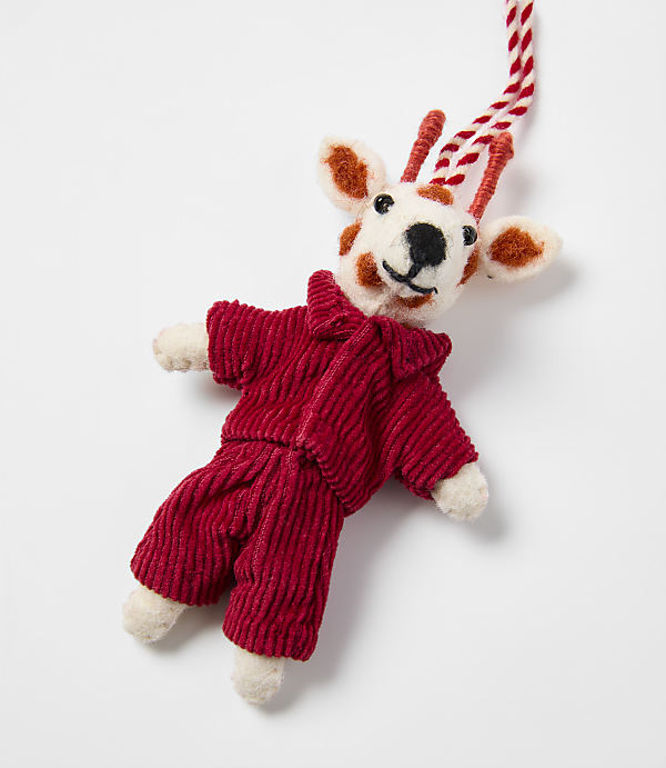 A small, spotted felt deer wearing a red corduroy outfit lies against a plain white background.
