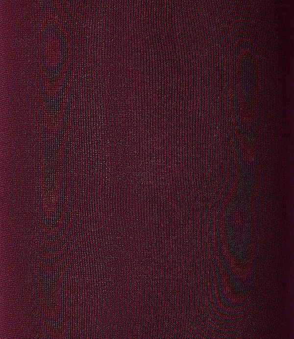 A close-up of a deep burgundy fabric texture fills the entire foreground and background.