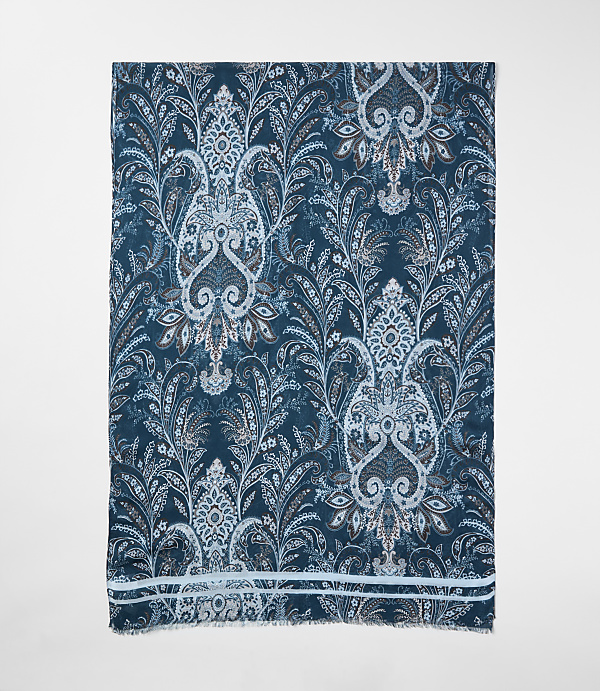 A blue and white paisley patterned shawl is centered against a plain white background.