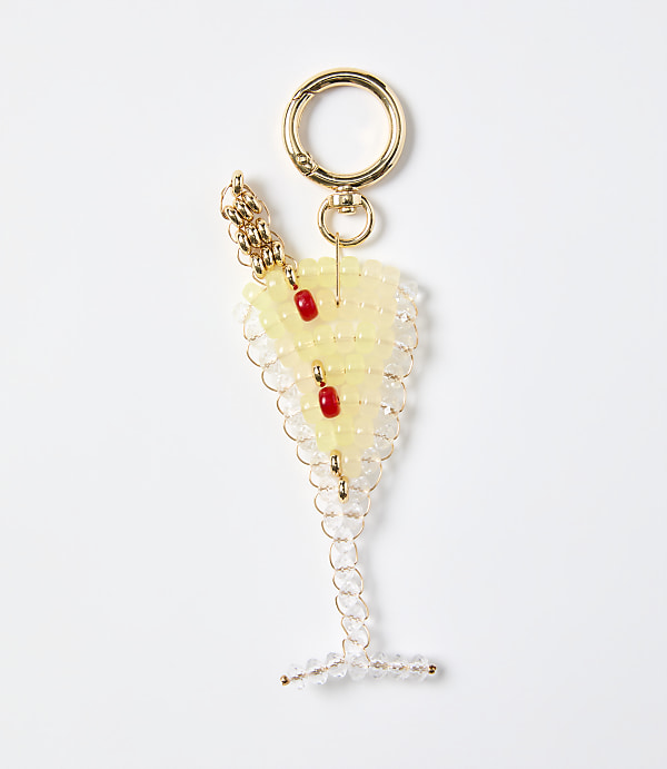 A beaded keychain shaped like a cocktail glass with red cherries sits against a plain white background.