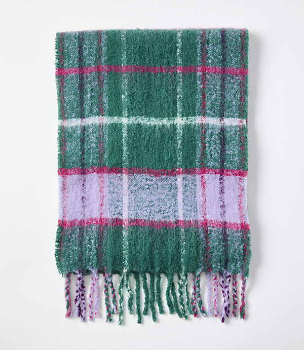A green, pink, and purple plaid fuzzy scarf with fringed edges lies flat against a plain white background.