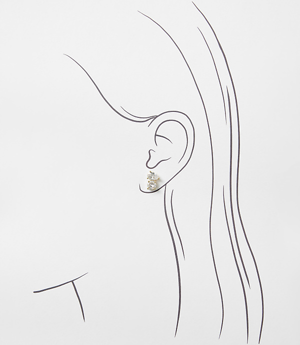 A sparkling diamond stud earring is placed on a minimalist line drawing of a woman's profile against a plain white background.