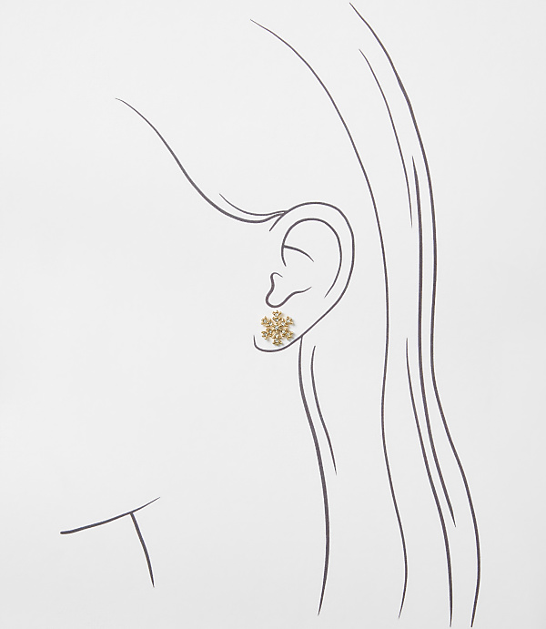 A gold snowflake earring is positioned on a minimalist line drawing of a woman's profile against a plain white background.