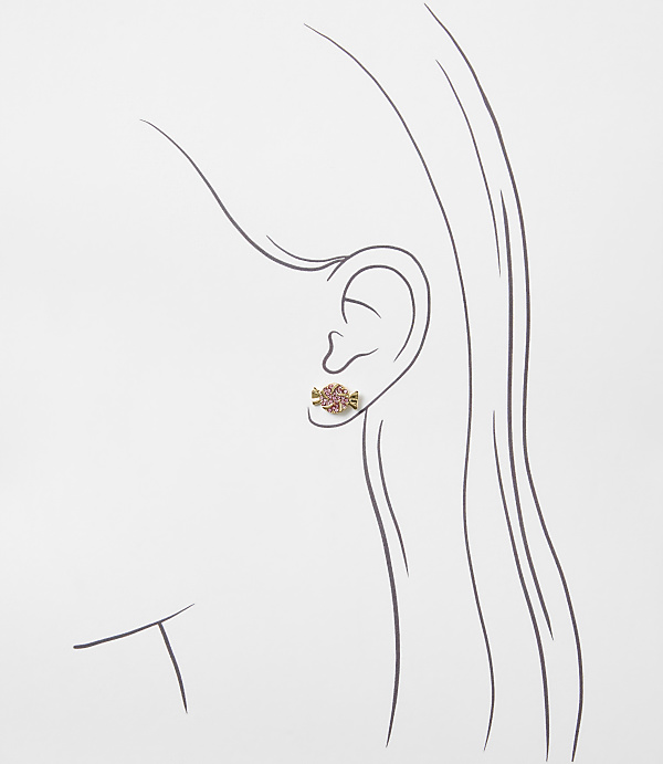 A small pink candy-shaped earring is worn on the ear of a minimalist line drawing of a woman's profile against a plain white background.