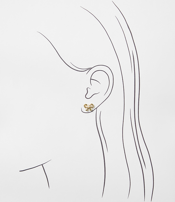 A gold bow-shaped earring is worn on the ear of a minimalist line drawing of a woman's profile against a plain white background.
