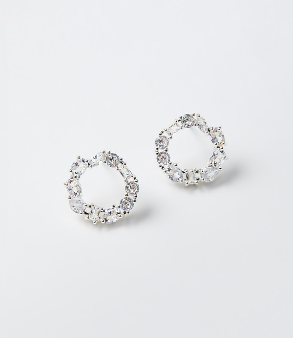 Two circular crystal earrings rest on a plain white background.