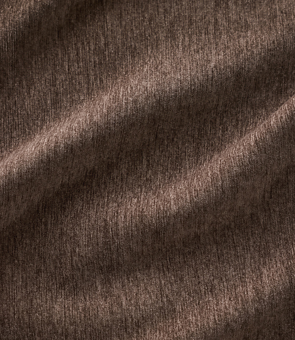 Brown textured fabric with soft folds in the foreground and a consistent woven pattern throughout the background.