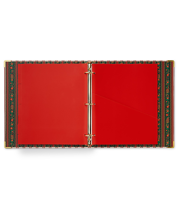An open red binder with gold rings and a patterned border sits against a plain white background.