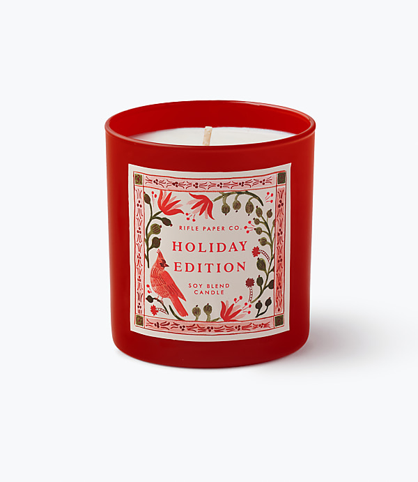 A red holiday-themed soy blend candle sits centered against a plain white background.