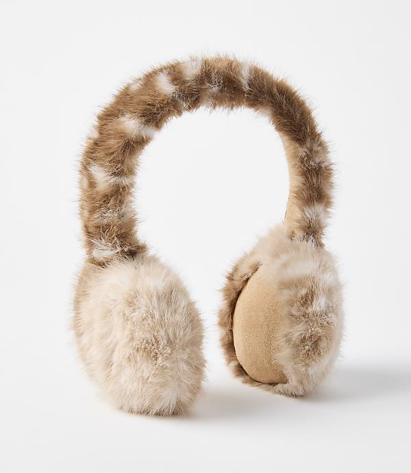 Fluffy brown and white earmuffs rest on a plain white background.