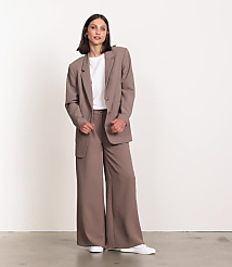 A woman in a black top and wide-leg pants stands against a plain white background. carousel Product Image
